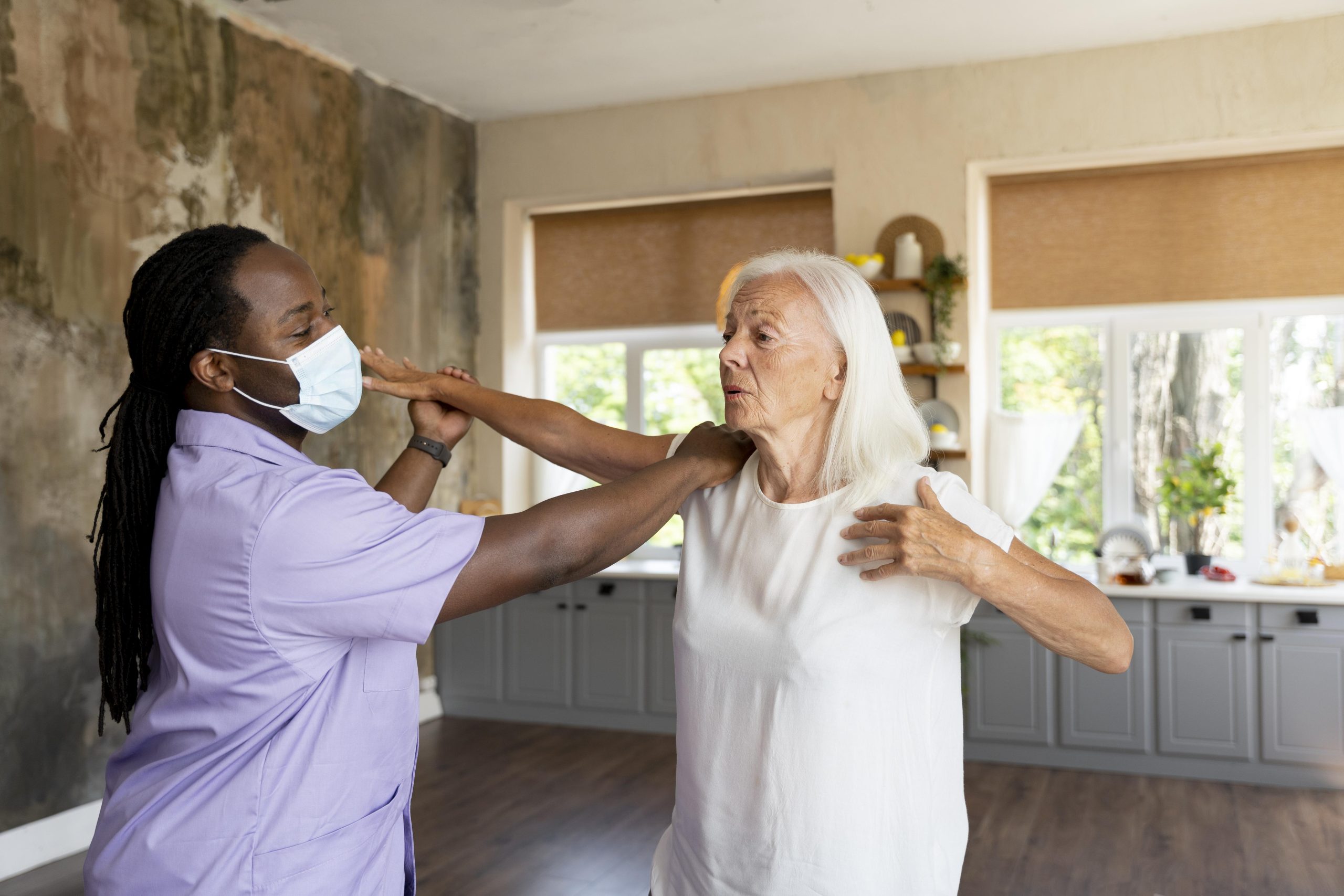male-social-worker-taking-care-old-woman (1)