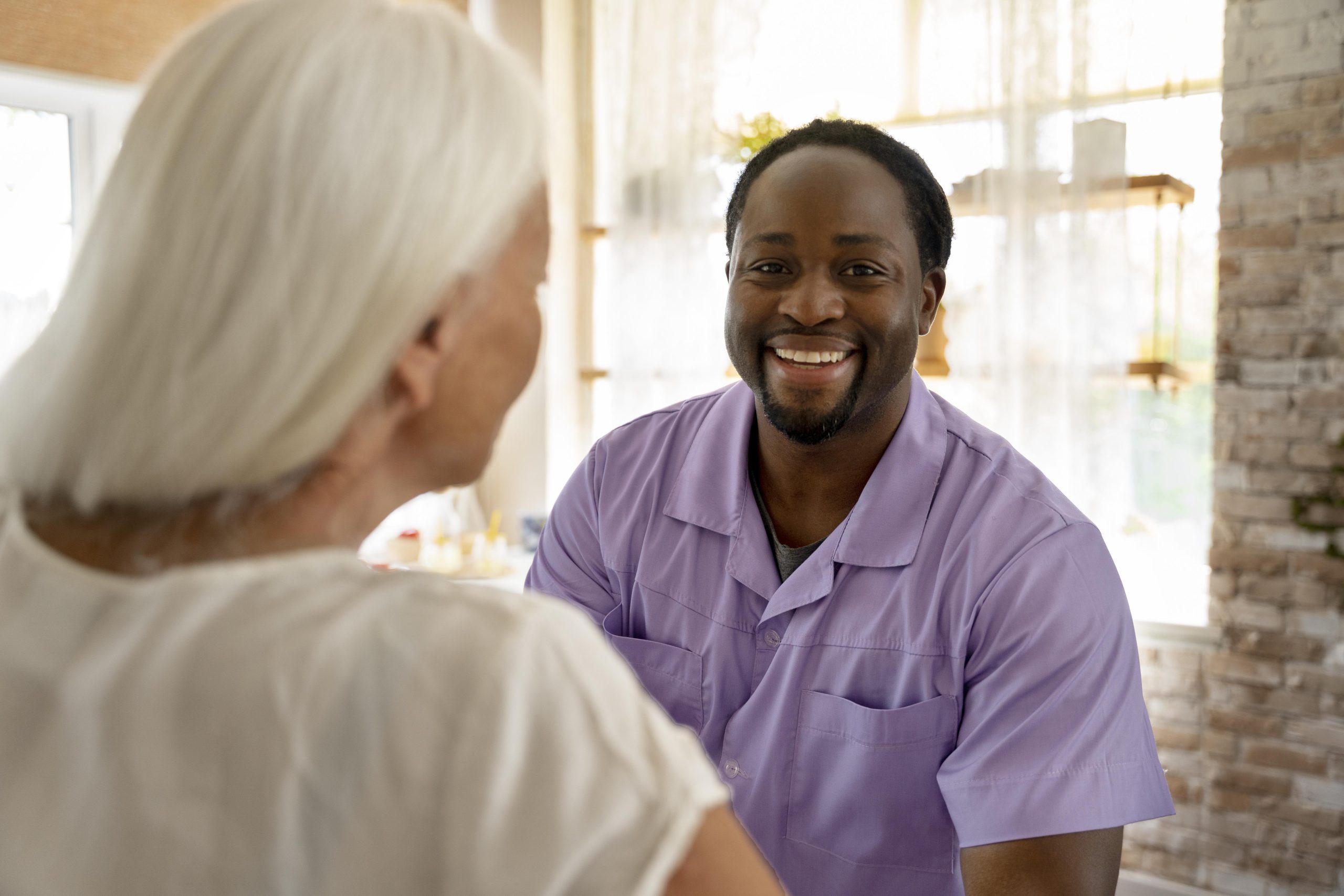 male-social-worker-taking-care-old-woman